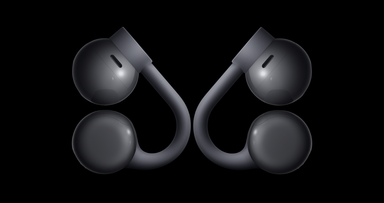 Both CMF Clip Pro buds in dark grey, seen from the front: an acoustic pod and a counterweight joined by a flexible clip arm.